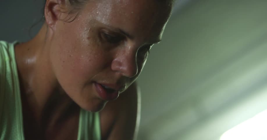 A face of a woman that is sweat of her being tired