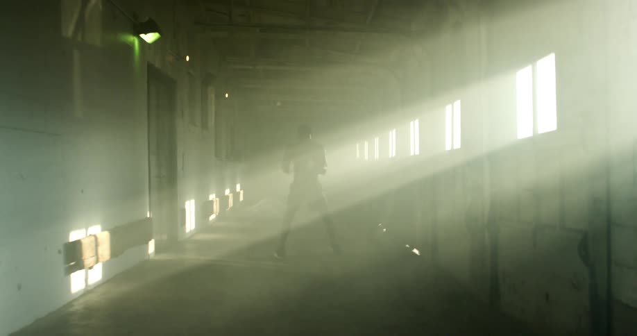 Man inside a facility practicing punches and kicks in boxing