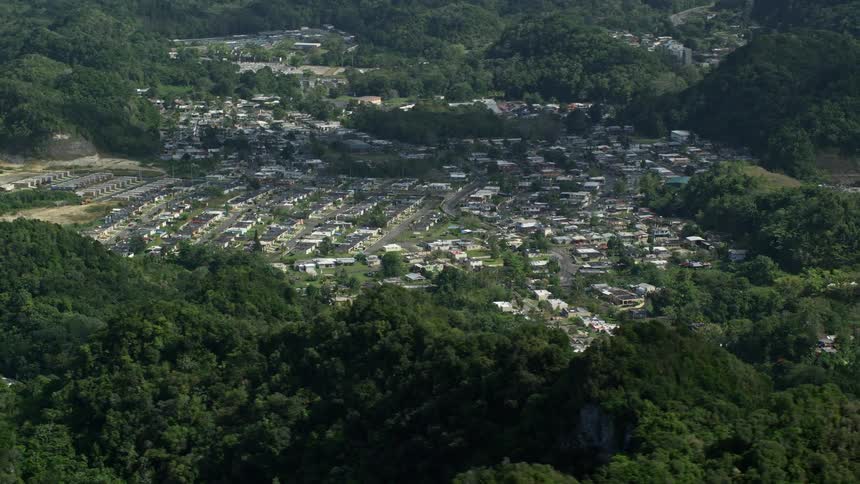 A town surrounded by lush green mountains