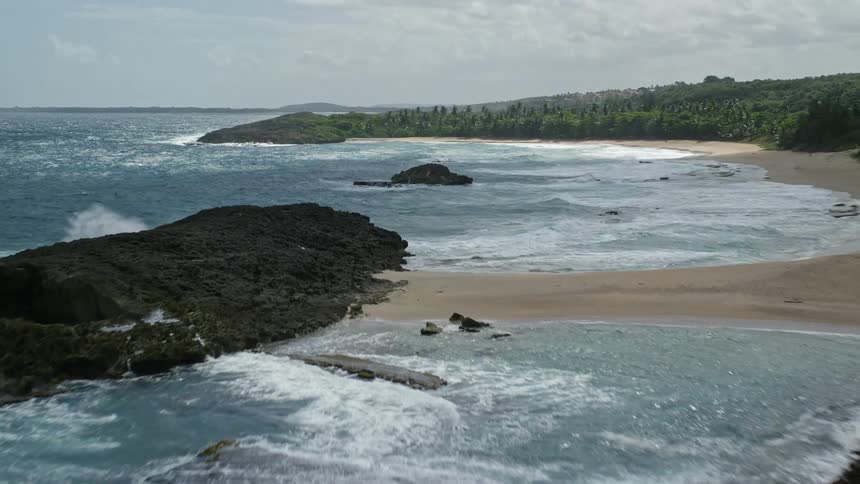 Waves crash against the island