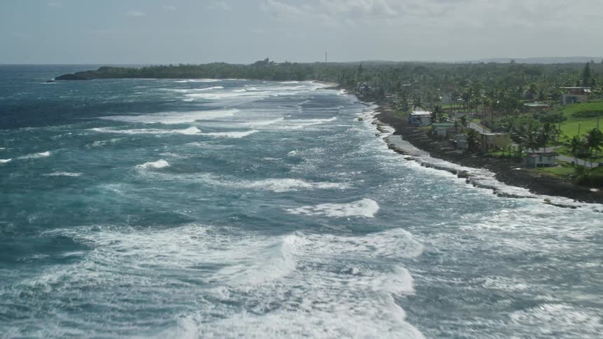 Aerial panorama of a beach with access to tropical vegetation with houses and hotels
