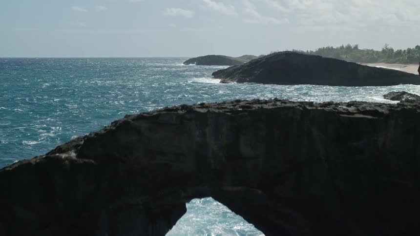 Strong waves pound islands right off of a coastal area