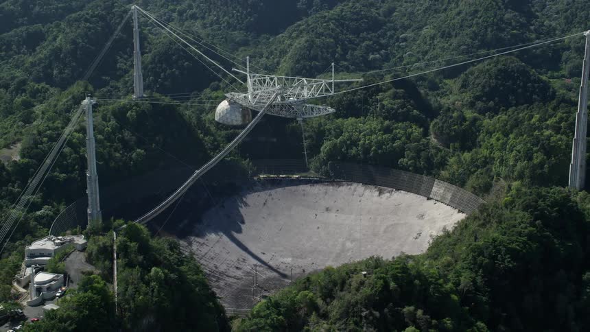 Aerial of a metal and concrete structure in the forest during the day
