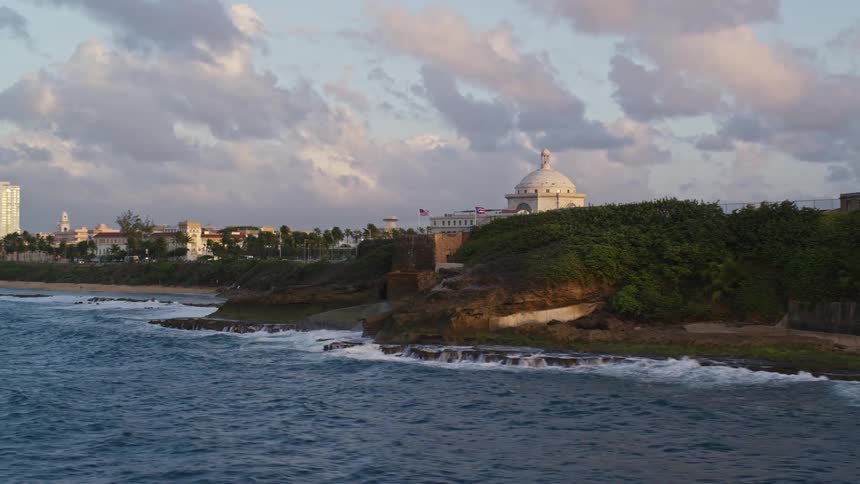 An ancient fort sits on the coast guarding a large metropolitan city