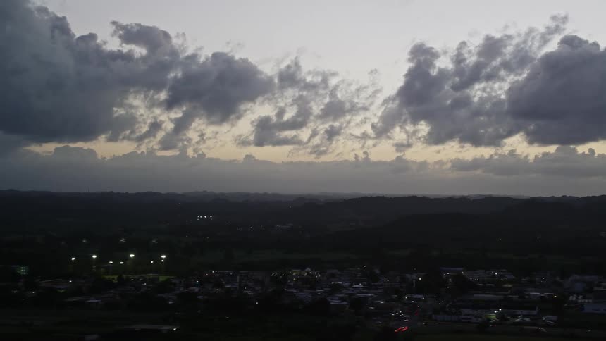Dark clouds hover over a small city