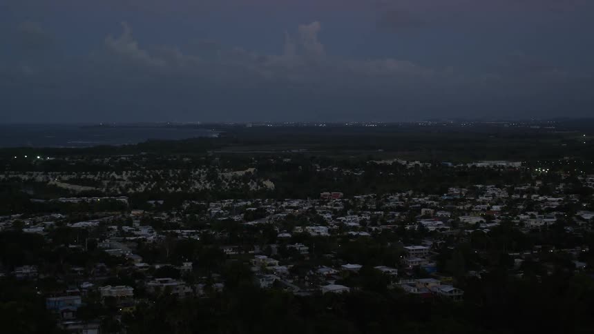 Aerial panorama of an urban city amidst greenery and by the seaside