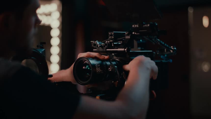 A man removes the lens from the camera