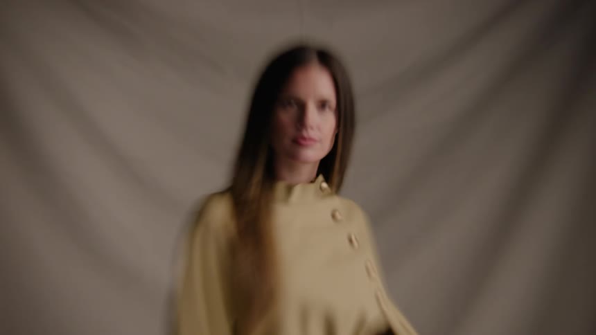 A female model dances and poses for a photoshoot