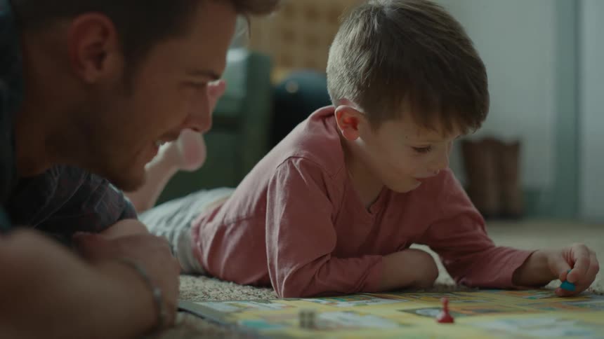 A father and son are playing a board game