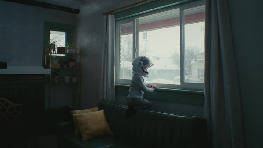 A child is looking out the window
