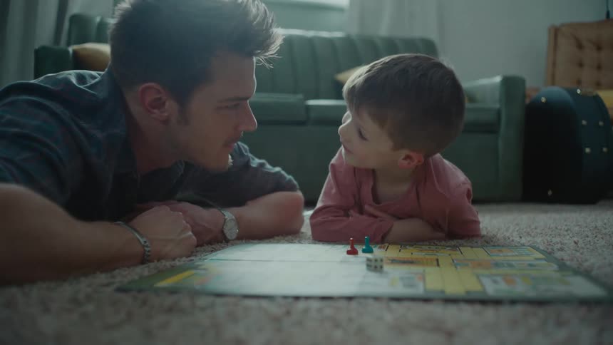 A man and a boy play a board game