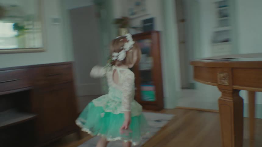 Children run around a dining table