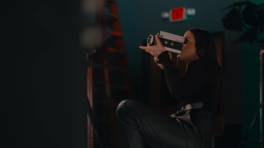 Woman in a studio using a recording camera
