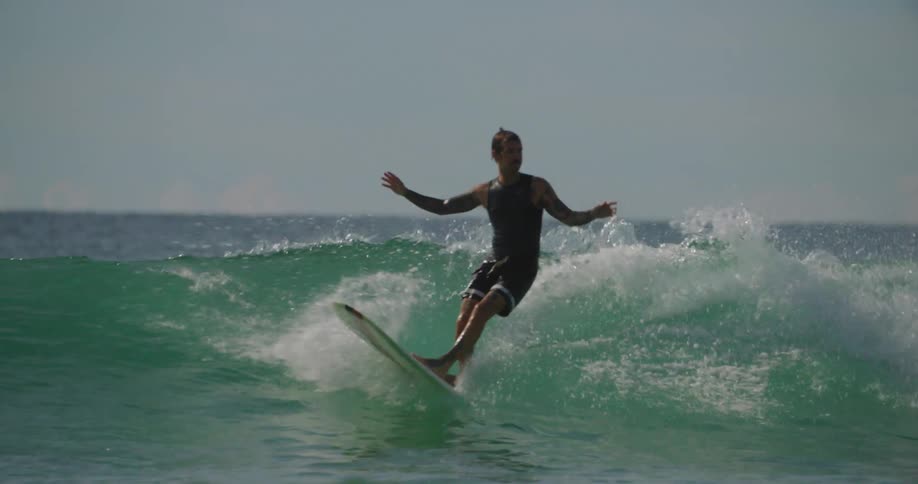 Man riding a wave with a longboard