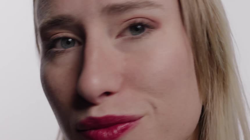 A woman smiles and winks