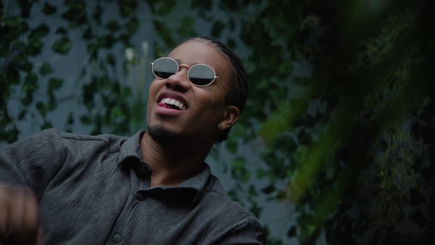 Young man wearing sunglasses modeling for the camera