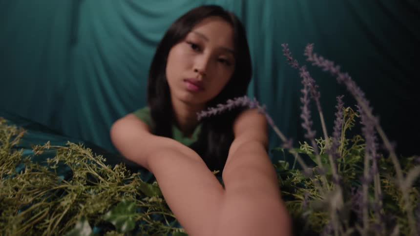 An asian wearing a ring stares