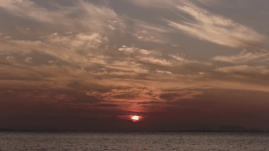 The sun sets over the ocean
