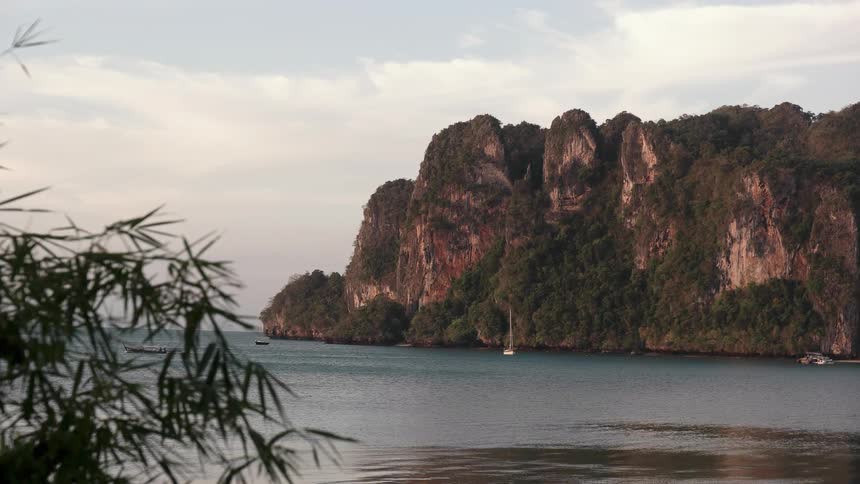The ocean water flows along the cliff lined shoreline