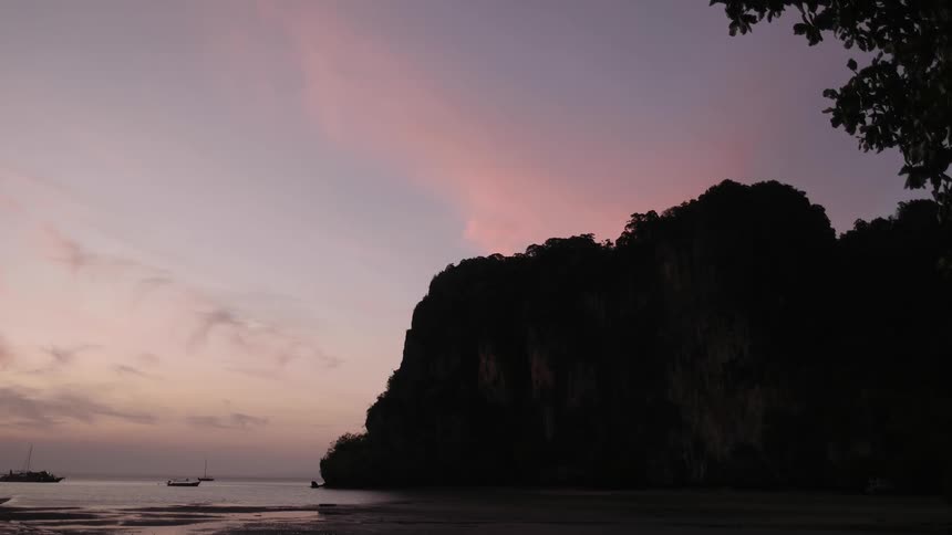 The sun sets over a tranquil beach
