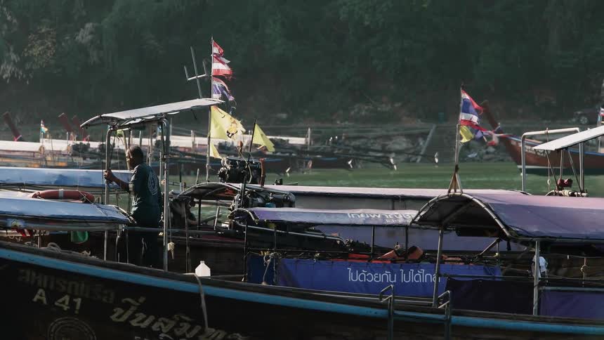 Boaters push off from the dock into the water
