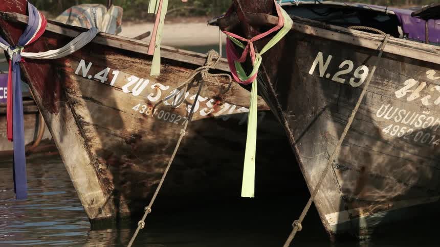 Boats decorated with ribbon are anchored in the water