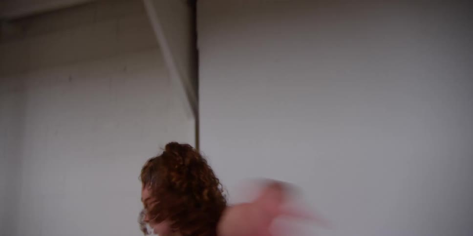 Female dancer moves through acrobatic routine in dance studio