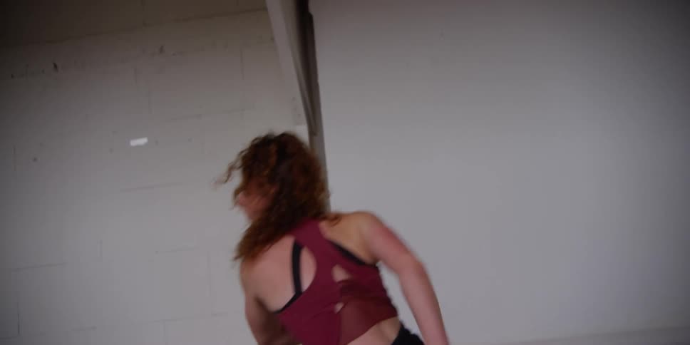 A dancer practicing a choreography that includes handstands