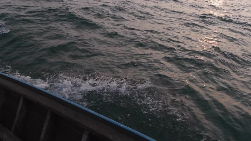 Water splashes against the hull of a boat