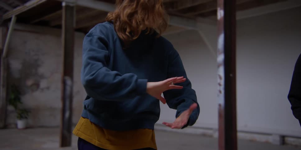 Two women are rotating their hands around