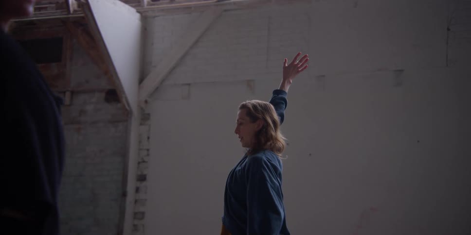 Two women indoors practicing a dance choreography