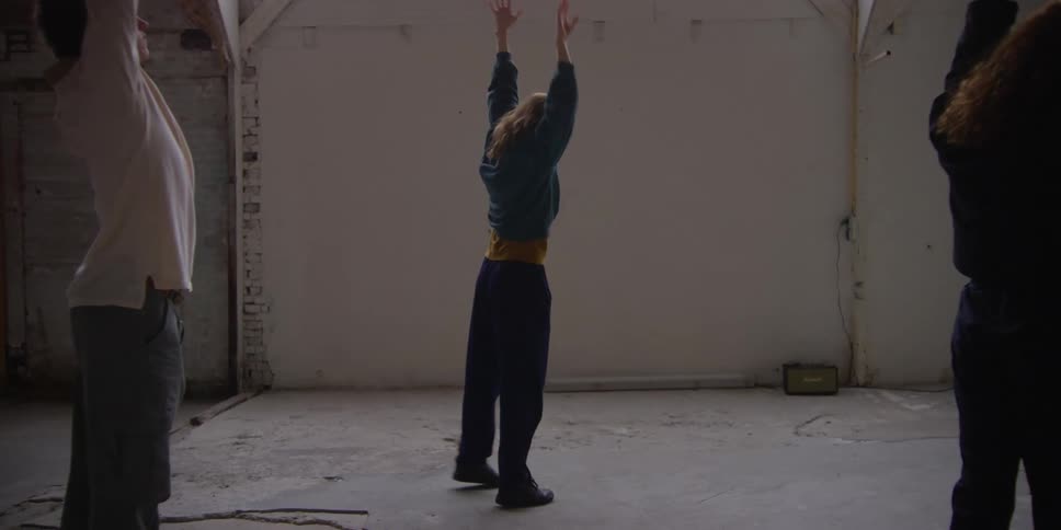People dancing modern art in a room during the day