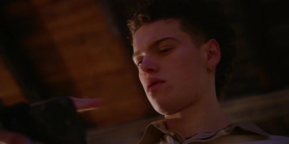 Portrait of a man holding a cell phone and watching while dancing with his arm