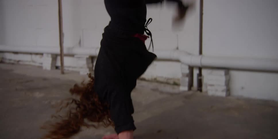 A woman is dancing and flipping