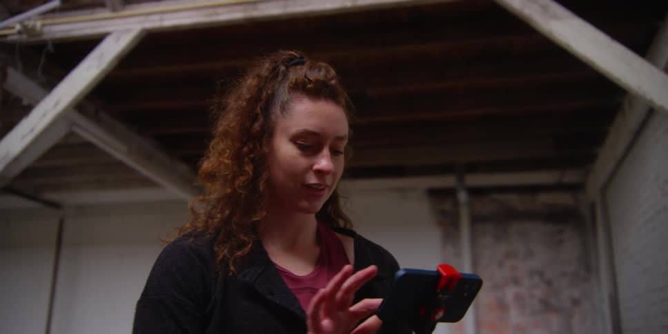 A lady nodding at her phone