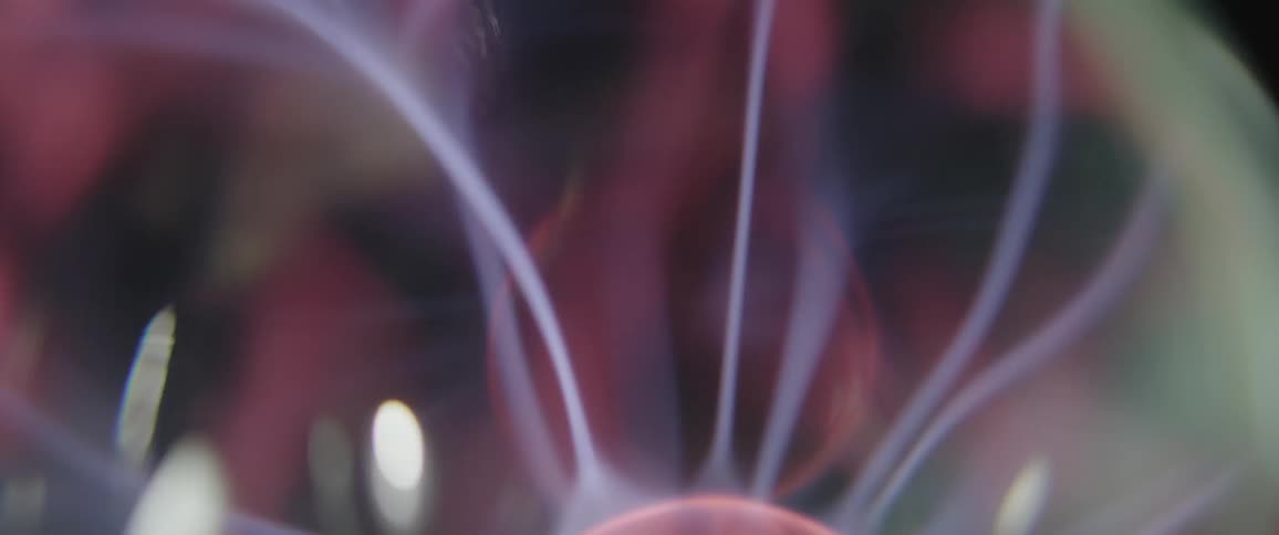 A closeup of a plasma ball with smoke coming out of the top