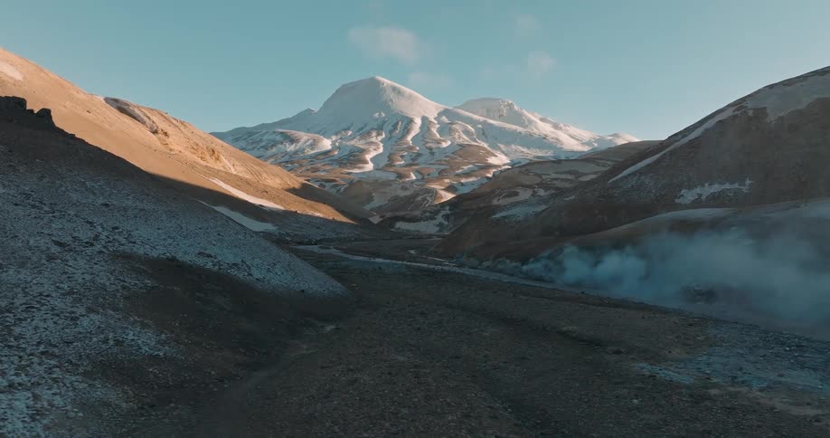 Steam roils in a mountain valley