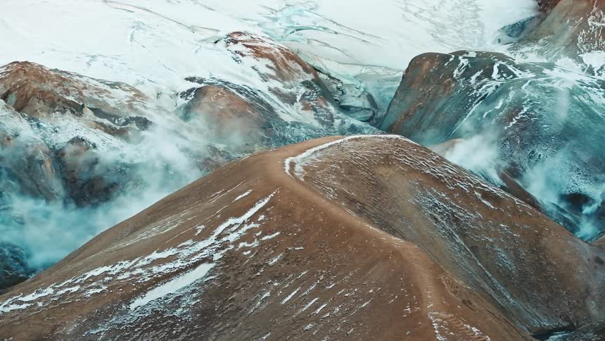 Natural steam rise from a mountain range
