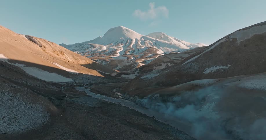 Smokes in a mountain area at midday