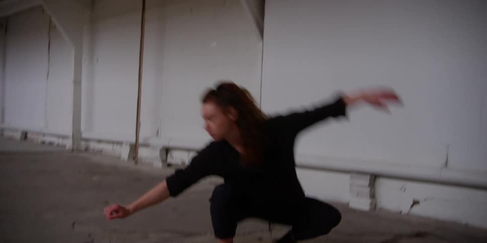 A woman practices a dance routine