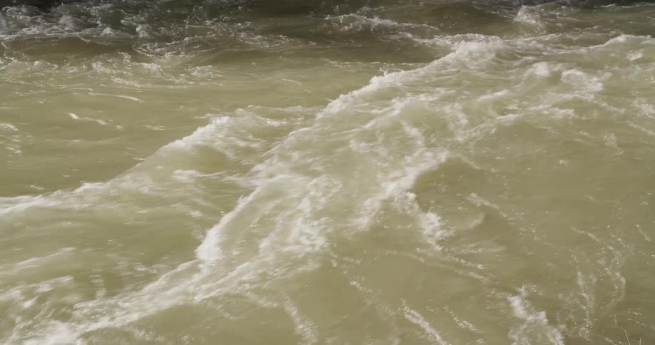 A river with a strong current during a daytime flood