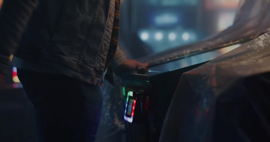 A person playing an arcade machine