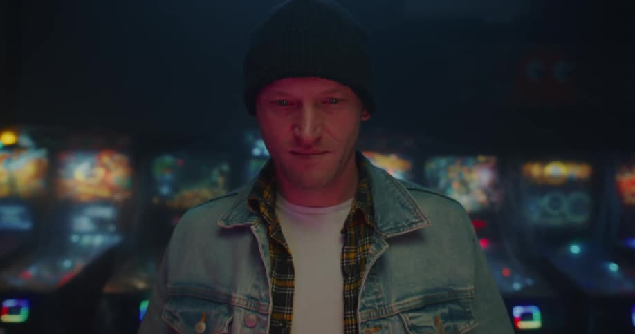 A night clip of a man in a denim smiling
