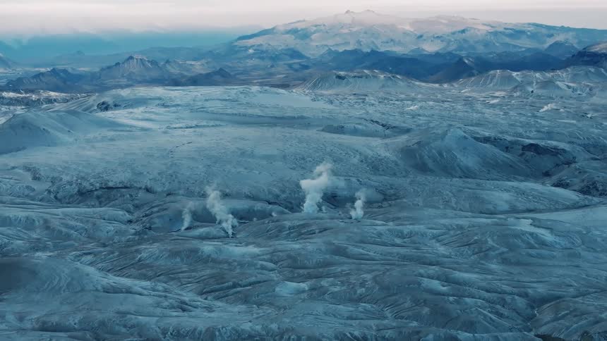 Steam rises from the mountains