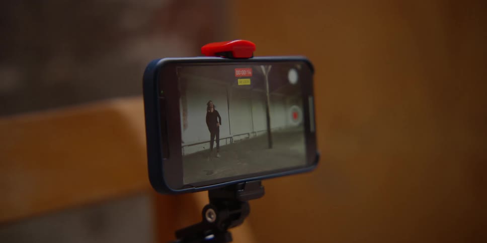 A woman films herself dancing and then picks up the camera