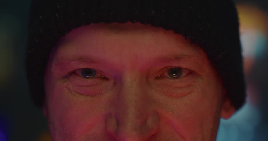 Closeup of a mans blue eyes at night