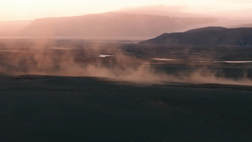 Steam rises from a mountain valley