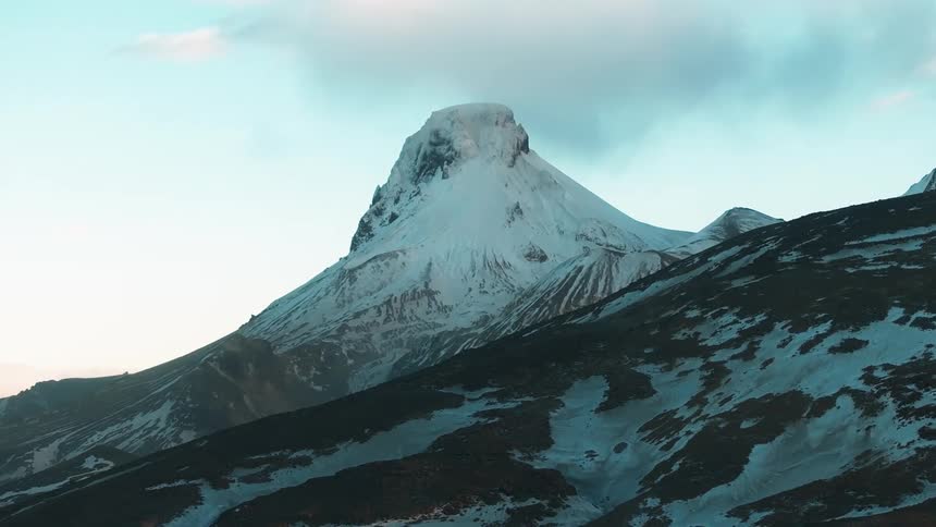 Aerial of a snowcovered mountain peak during winter