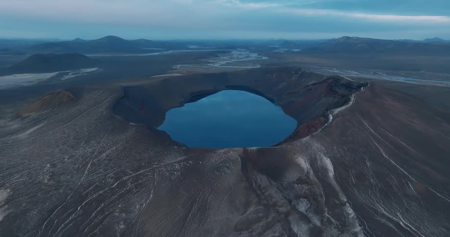 A camera pans over a mountain with a huge canyon in its center
