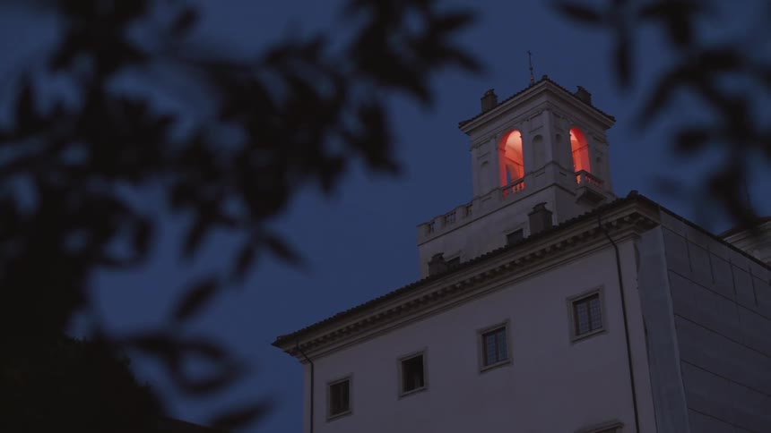 A clip of abuilding with a light house at the top